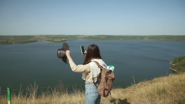 Woman Taking Photos on Smartphone of Bakota Area