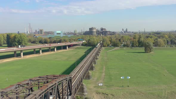 Freight Train Crossing an Iron Bridge Spanning a River