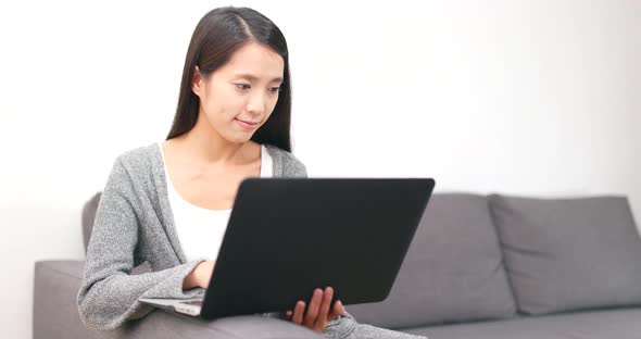 Woman working on notebook computer at home