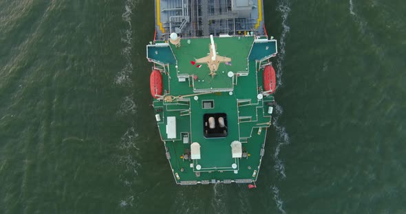 Aerial establishing shot of large tanker boat in water