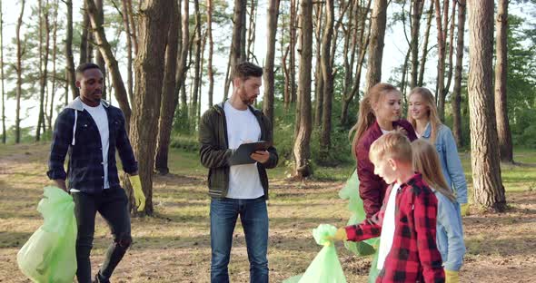 Volunteers Collecting Garbage all Over the Park and Putting Filled Plastic Bags