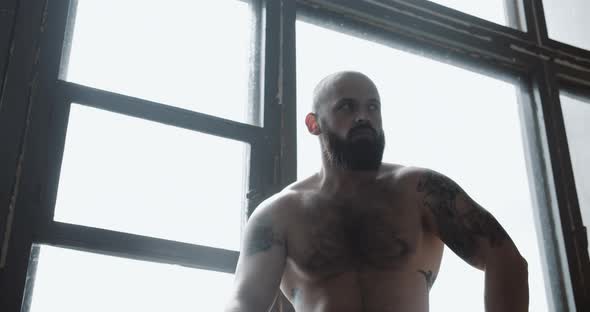 Low Angle Portrait of Young Shirtless Muscular Man on Break After Power Training Exercise at Large