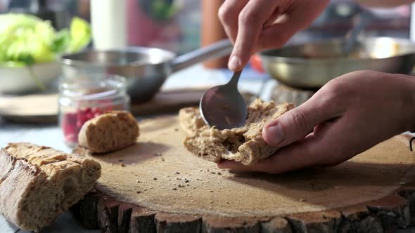 Hands Prepare Sandwiches.