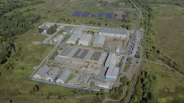 Manufacturing Area in Field Drone View. Aerial Top Down View of Modern Technology Manufacturing