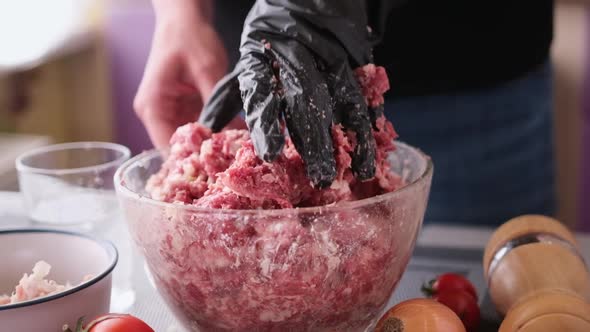 Kneading of Minced Meat with Onion and Spices in a Glass Bowl