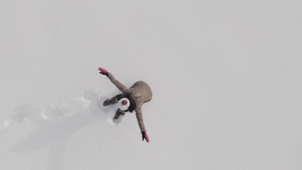 Woman making a snow angel