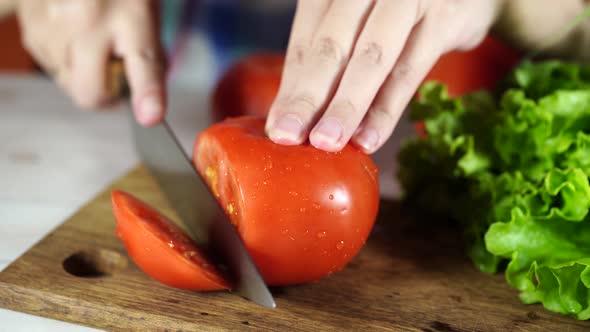 Slice Tomatoes in Half. Red Tomato on The Chopping Board, in The Kitchen