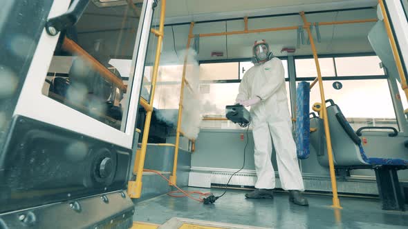 Person Disinfects City Bus During Coronavirus Pandemic.