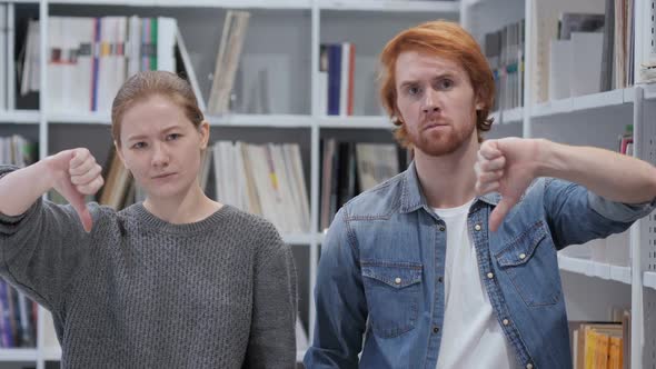 Thumbs Down By Couple Man and Woman Office Portrait