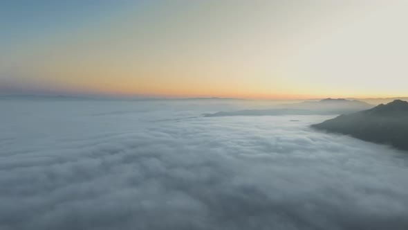 Drone camera flies through clouds over mountain peaks in Malibu Canyon, Calabasas, California, USA