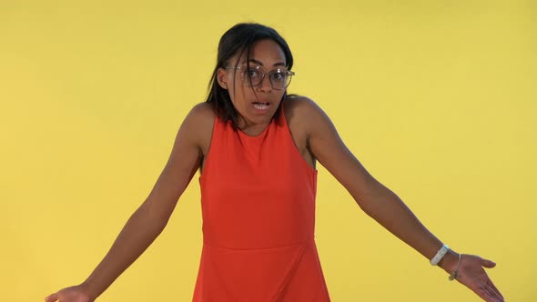 African Young Woman Saying "I Don't Know" and Spreading Her Hands To the Sides