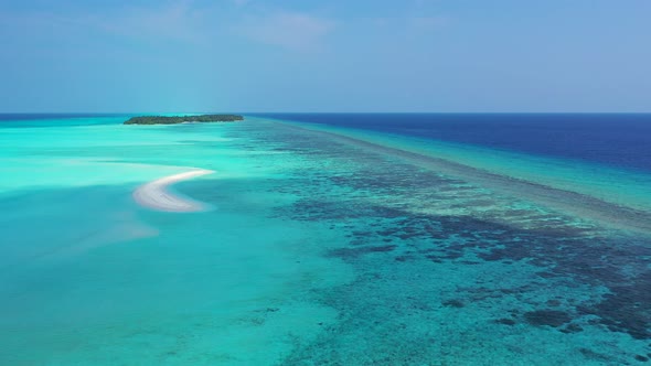 Beautiful fly over clean view of a white sandy paradise beach and blue ocean background in colorful 