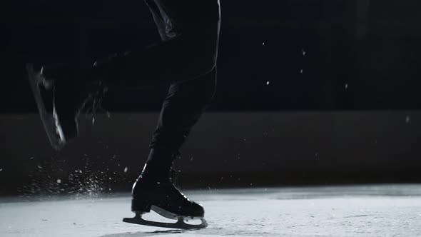 Single Figure Skater Man is Doing Steps Sequence on Ice Rink Closeup of Feet Shod Skates Champion is