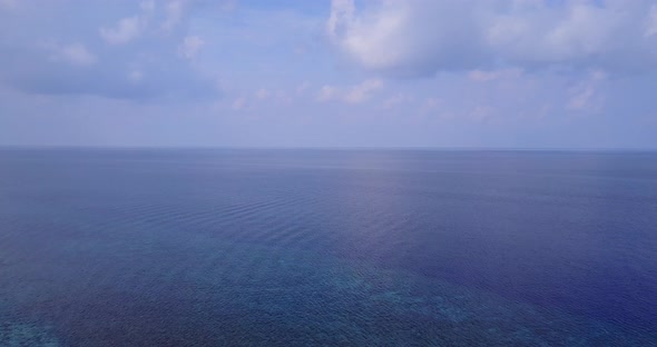 Beautiful fly over copy space shot of a summer white paradise sand beach and aqua blue water background