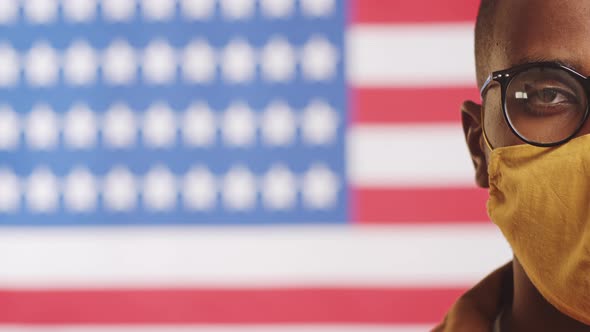 Half Face of Black Man in Face Mask on U.S. Flag