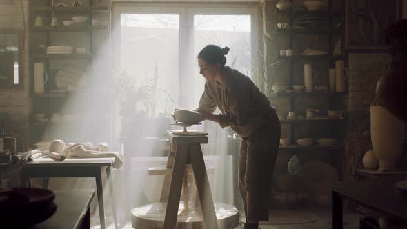 Woman Is Taking Raw Clay Pot Off Pottery Wheel