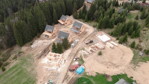 Cottages at winter ski resort in summer. Houses and villas under construction