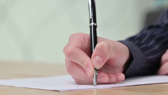 Close Up of Female Hand Writing on Paper