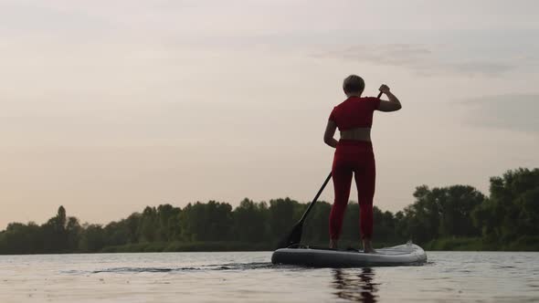 Woman on SUP Board on River