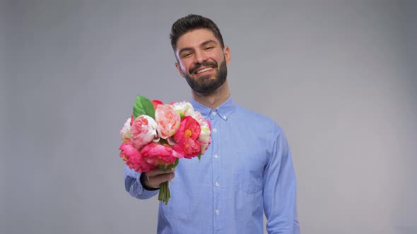 Happy Smiling Young Man with Bunch of Flowers