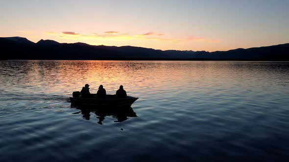 Aerial view flying alongside fishing boat as person casts