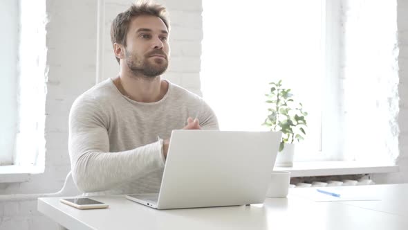 Pensive Businessman Thinking and Working on Laptop