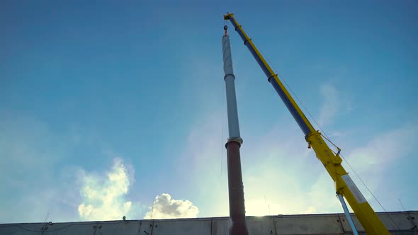 Build an Industrial Site. A Giant Crane Installs a Pipe.