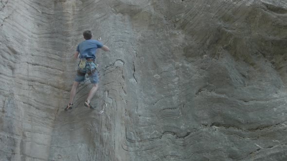 A man rock climbing up a mountain.