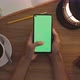 Top View Woman Uses Thumb Touch On Green Screen Of Smart Phone. Hobby Table Background. Chroma Key. - VideoHive Item for Sale