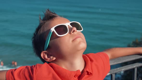 Cheerful Boy Spending Summer Holiday at Coastline