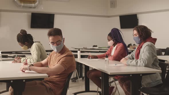 Student Throwing Paper Ball at Classmate