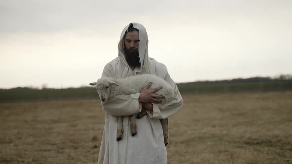 Jesus Christ Holds Sheep And Looks At The Camera