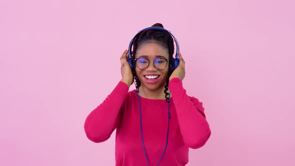 Cute Young African American Music Lover Girl is Listening to Music From Smartphone in Photo Studio