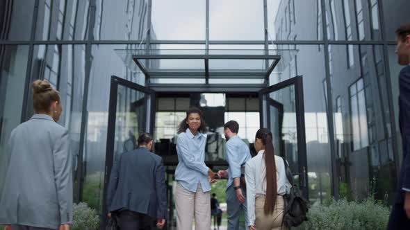 Successful Businesswoman Welcome Team at Office Entrance