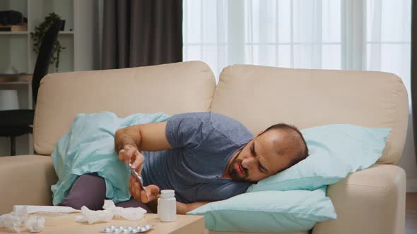 Sick Man Lying on Sofa