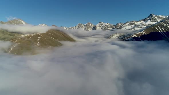 above the clouds, snowy mountains