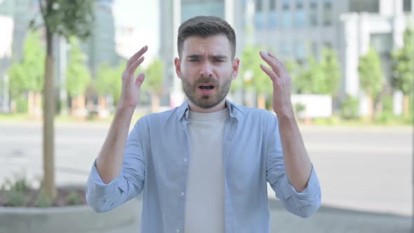 Outdoor Portrait of Young Man Shouting and Screaming