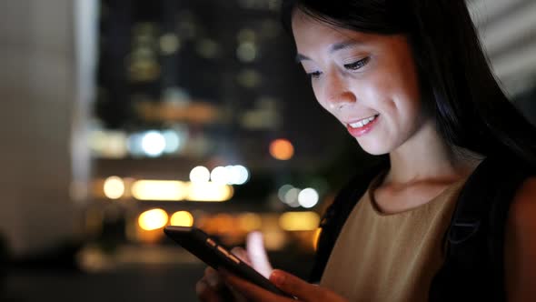 Woman use of mobile phone in city 