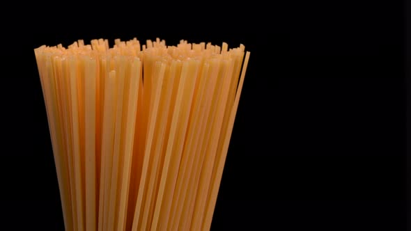 Spaghetti rotating on black background