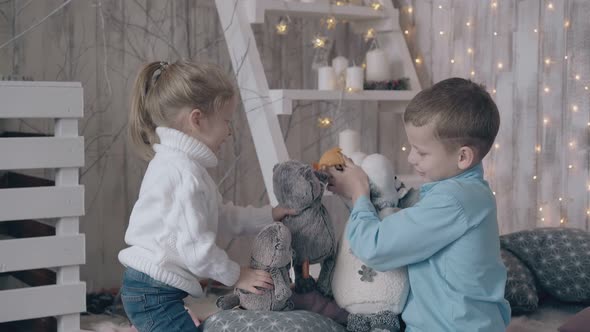 Elder Brother and Younger Sister Play Toys in Bedroom