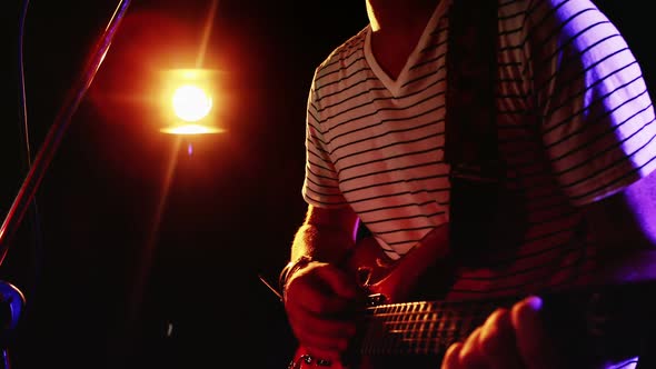 Man singing song while playing electric guitar 4k