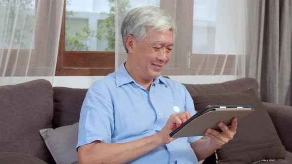 Asian Senior Chinese male search information about how to good health on internet while lying.