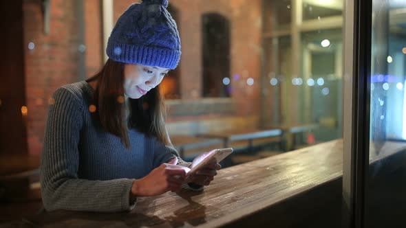 Woman use of mobile phone at night