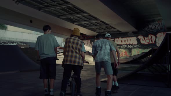 Teenage Friends Meeting Together in Urban Skate Park for Leisure