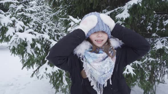 Portrait of a Happy Blueeyed Teenage Girl in a Snowy Park