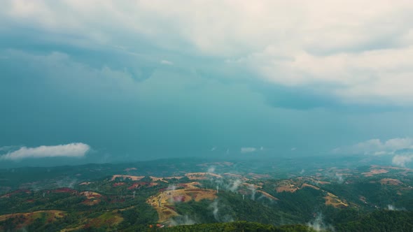 Aerial time lapse of fog over hills after rain