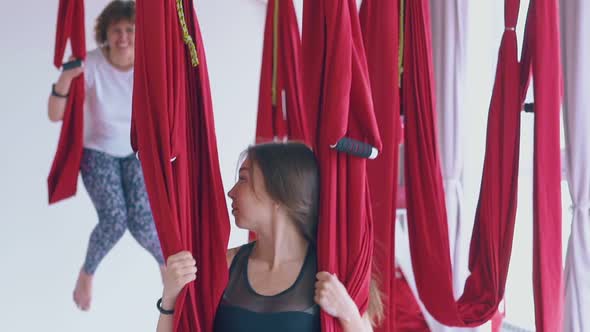 Woman with Bare Feet Laughs and Smiles Swinging in Hammock