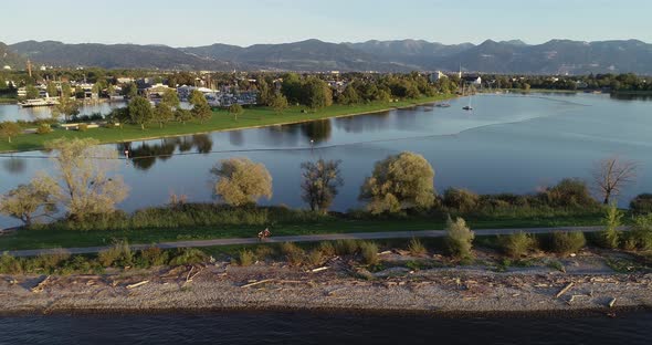 Aerial view of three person cycling a bike along Constance lake, Switzerland.