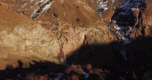 Panoramic wide view of mountain landscape with wild trees of juniper in a cold sunset time in winter