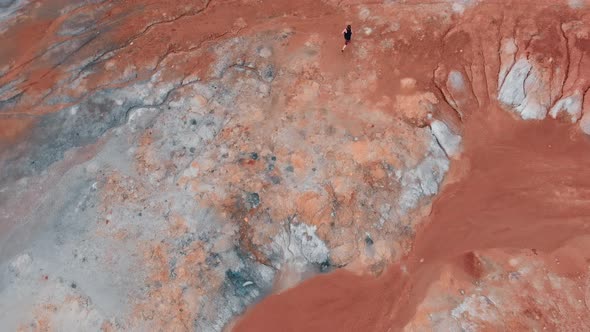 A Man Walking on Orange Clay Valley and Discovers a Bloody Red Pond